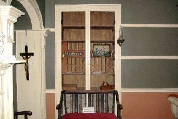 Inside La Maison Macdonell-Williamson House this photo shows the formerly John Macdonell's office with a shelf and seat