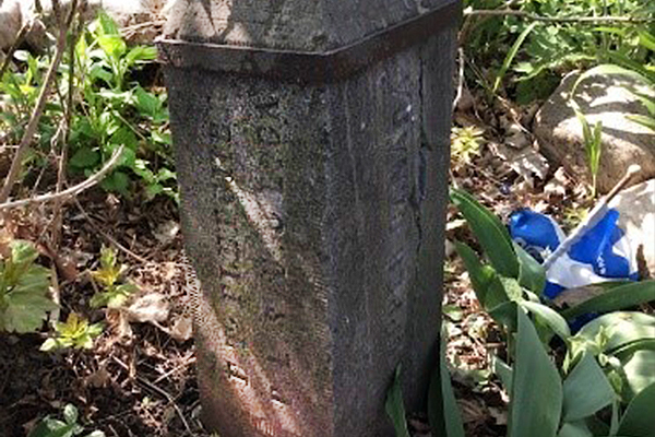 This is a photo of the old marker for La Maison Macdonell-Williamson House . It is made of stone and text is carved into it.