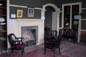 La Maison Macdonell-Williamson House presently the Tea Room with the fireplace and a few chairs around it